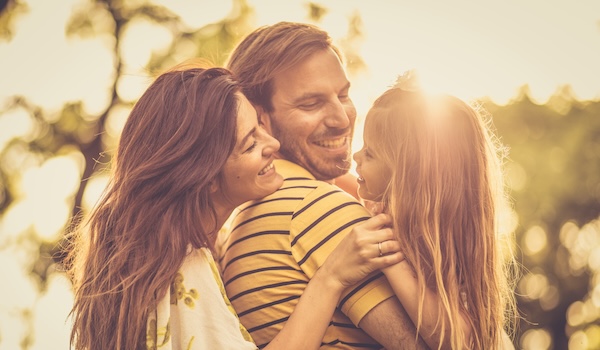 family embracing outdoors