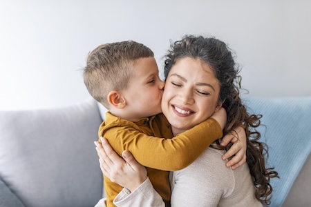 child kissing parent